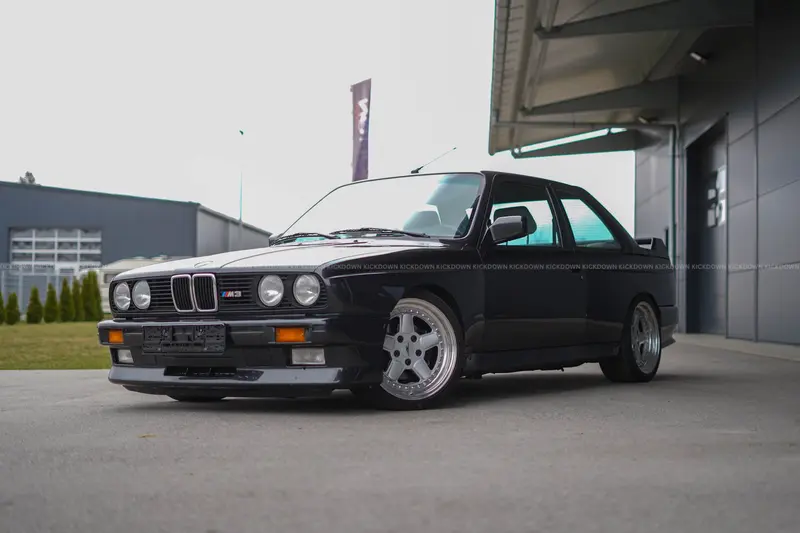 1986 BMW E30 M3 with a 2+ rating on its inspection report, fitted with AC Schnitzer alloy wheels, and equipped with a KW coilover suspension